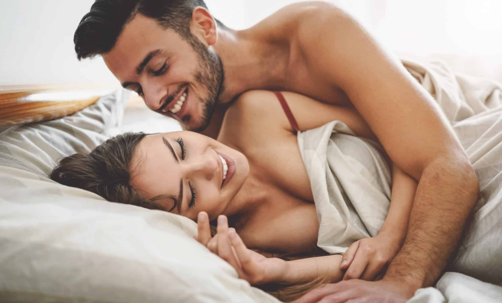 Couple sharing intimate moments in bed, representing enhanced desire and connection associated with those who buy Ultima-PT-141 10mg online for advanced sexual wellness and performance support.